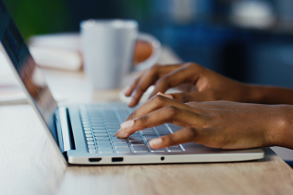 Student typing on a laptop