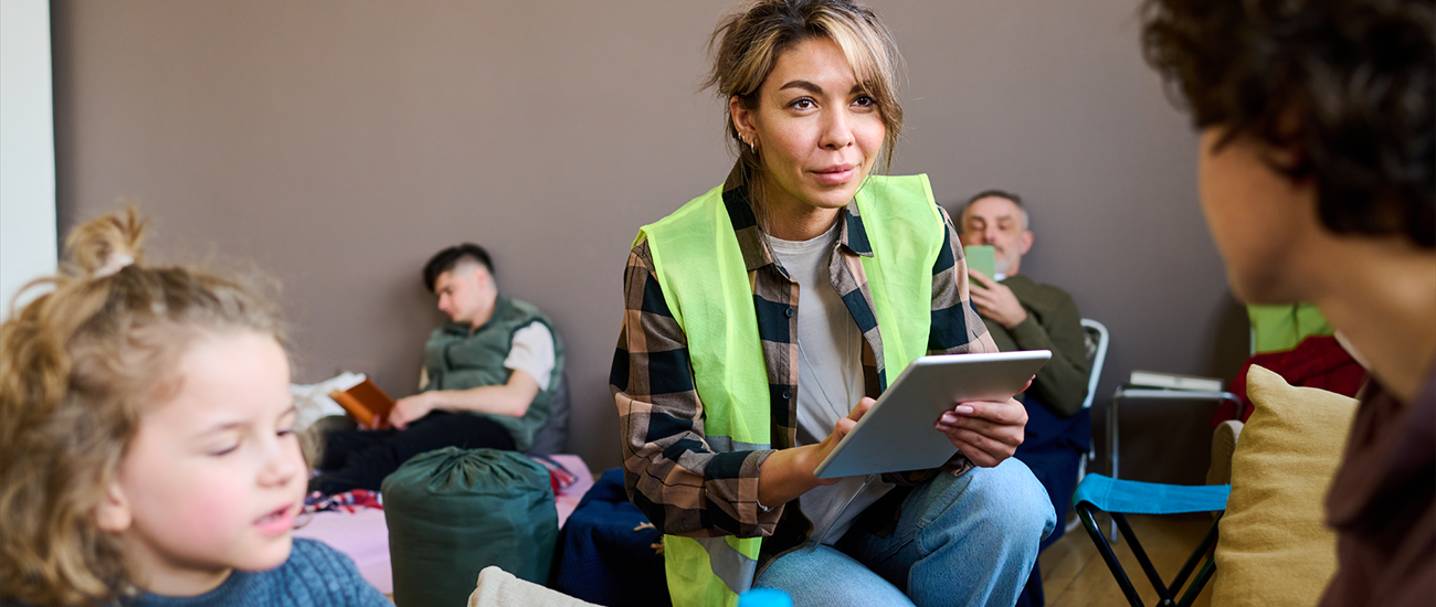 shelter volunteer with kids in a room